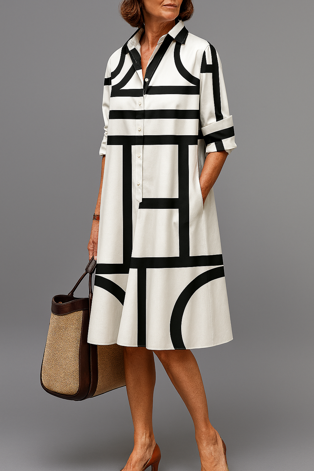 Robe midi Elua blanche et noire, col chemise, manches 3/4, boutons, motifs graphiques.
