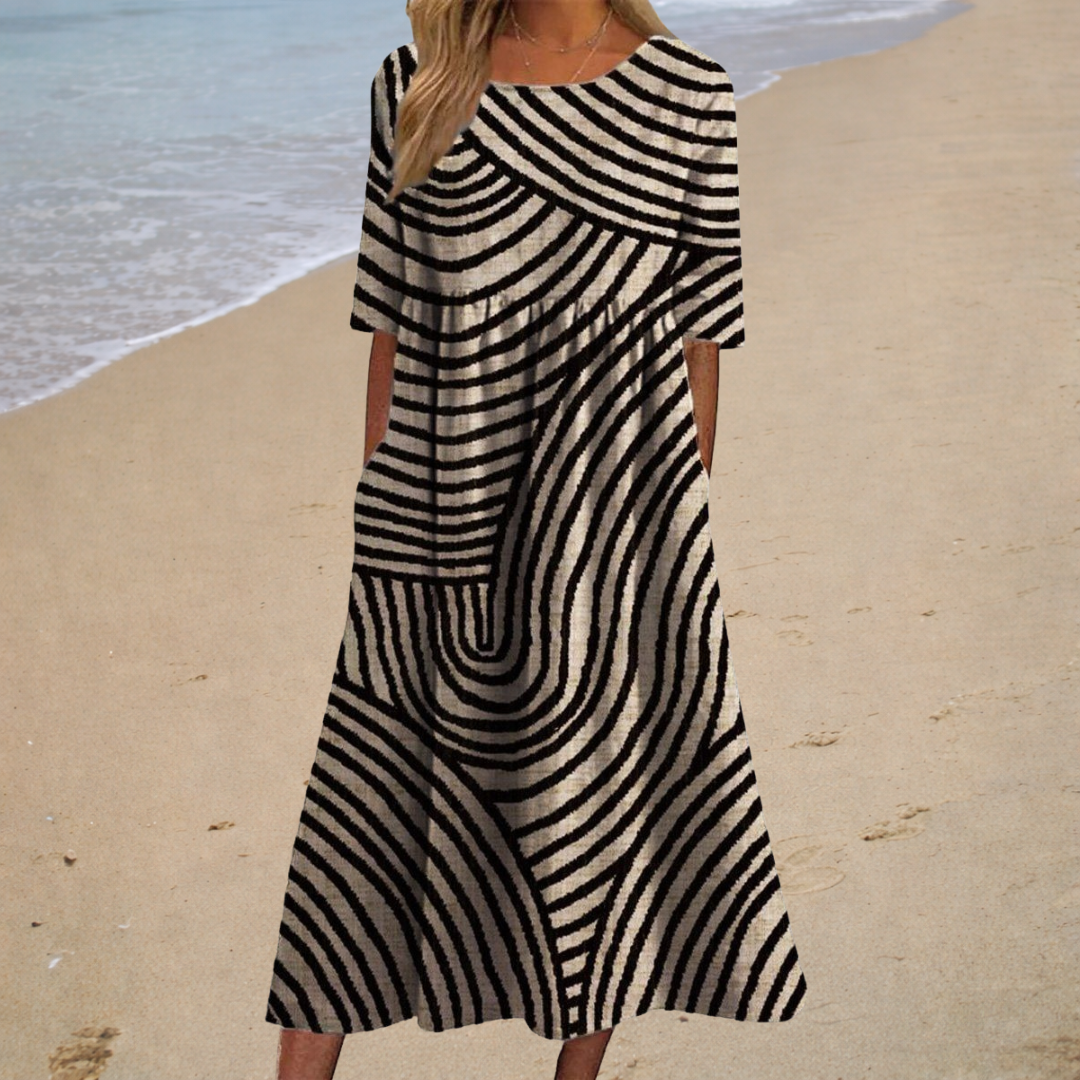 Robe midi noire et blanche à manches courtes, motif rayures ondulées, évasée.