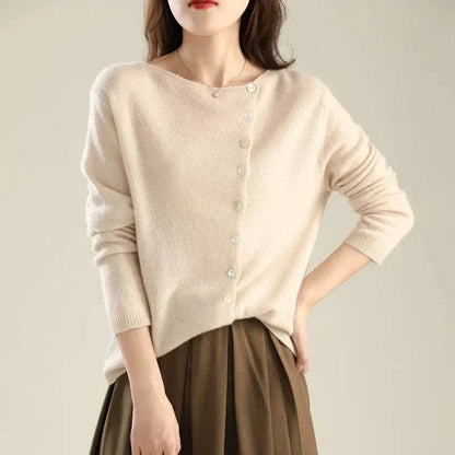 Gilet en tricot beige clair à boutons, encolure ronde et manches longues.