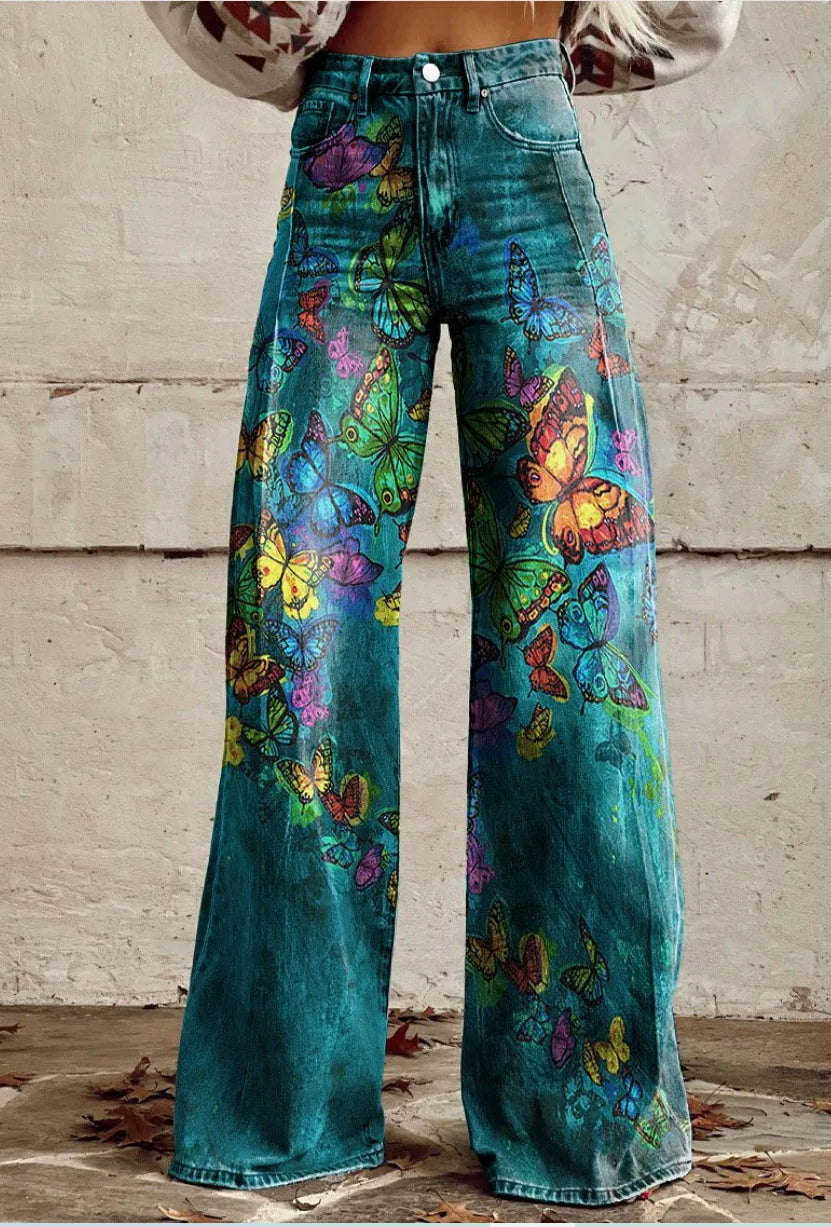 Pantalon ample bleu canard à motifs papillons, jambes évasées, taille boutonnée.