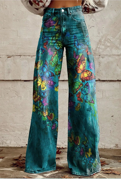 Pantalon ample bleu canard à motifs papillons, jambes évasées, taille boutonnée.