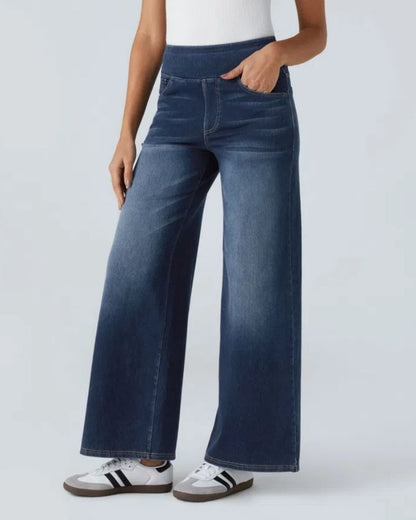 Jean à jambe large en denim bleu foncé, taille mi-haute, couture centrale et poches.