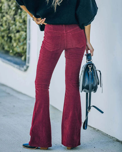 Pantalon évasé bordeaux en velours côtelé, poches et taille mi-haute.