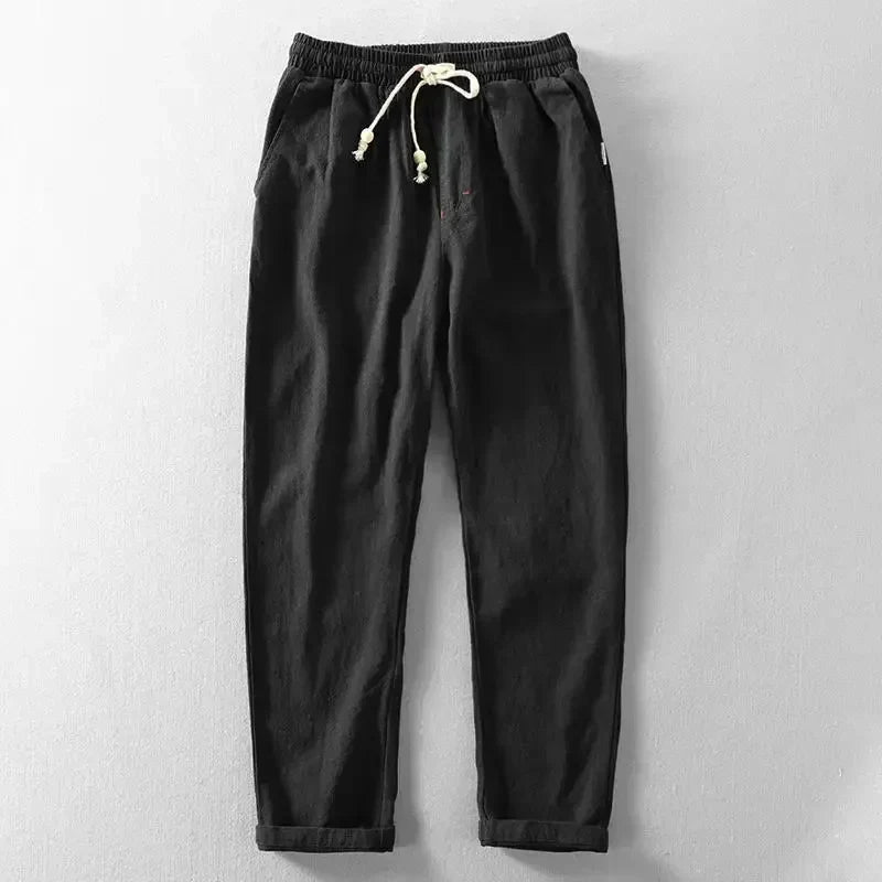 Pantalon décontracté noir, taille élastique, cordon de serrage à glands.
