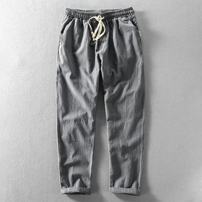 Pantalon décontracté gris, taille élastique, cordon de serrage avec embouts.