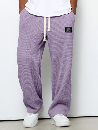 Pantalon ample violet à cordon, taille élastique, poches latérales et étiquette