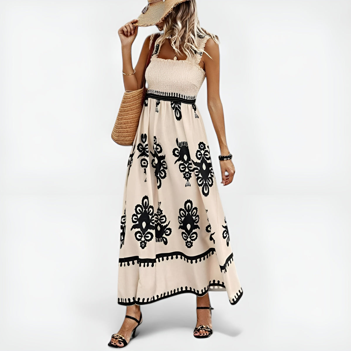 Robe d’été beige sans manches, imprimé noir ornemental, taille à cordon et jupe ample.