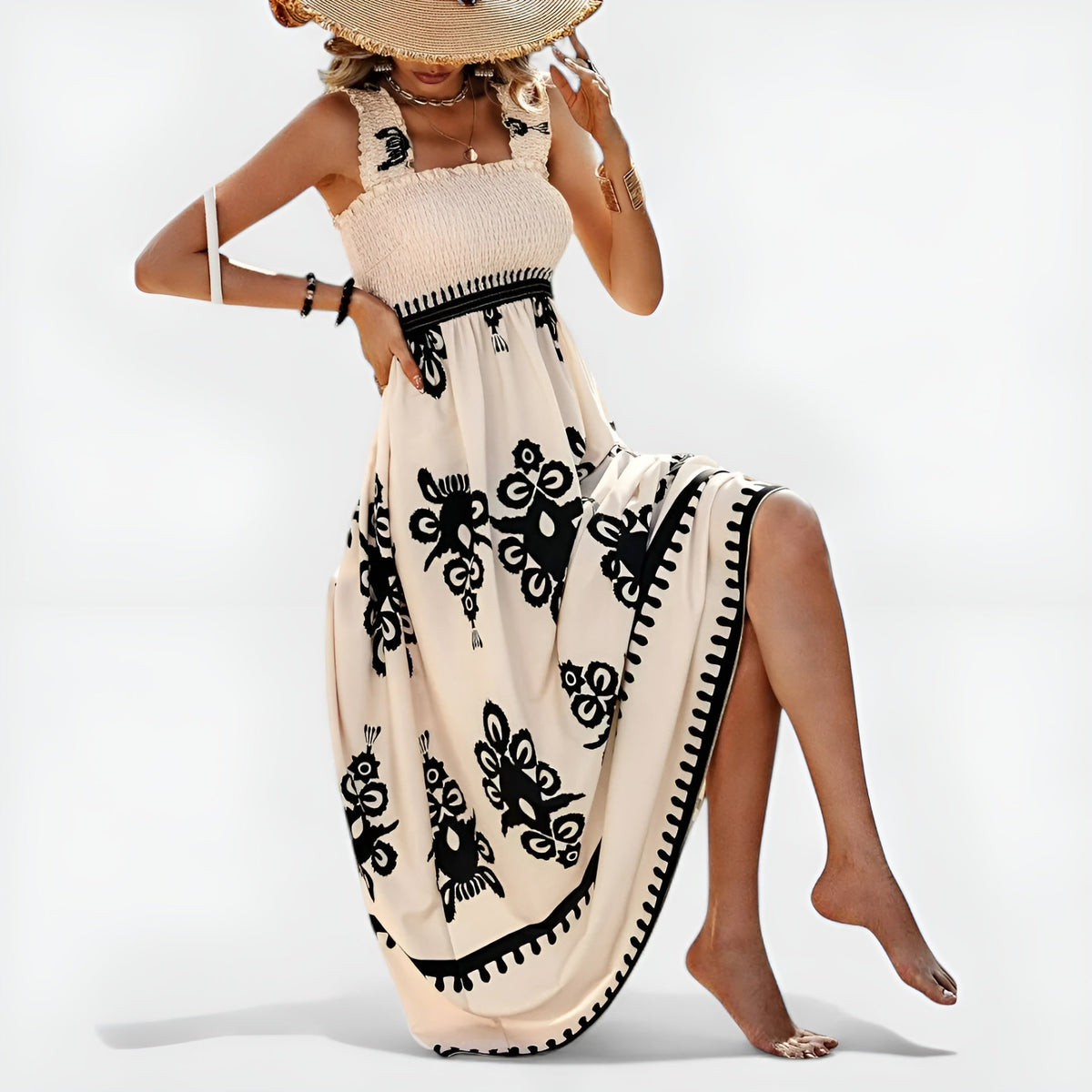 Robe d’été beige sans manches, motif floral noir, base large avec bordure contrastée.