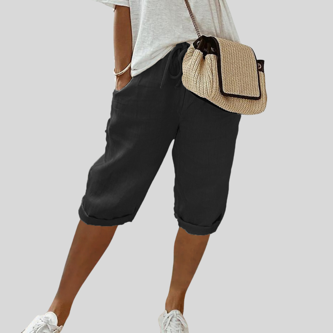 Short fluide noir à taille élastique et cordon, bas retroussé, mi-cuisse
