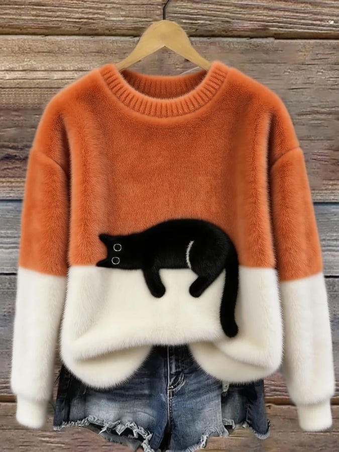 Sweat femme peluche orange avec bordures blanches et motif chat noir sur le devant.