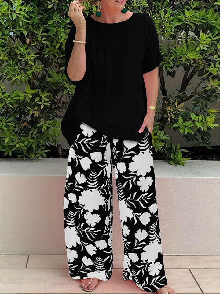 Ensemble élégant polyvalent : haut noir à manches courtes, pantalon large motif floral blanc et noir