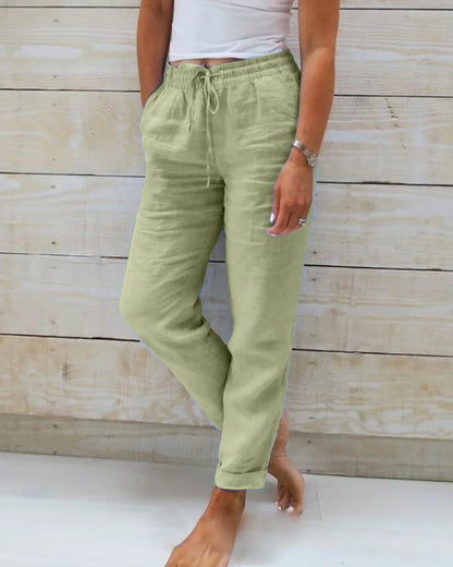 Pantalon en tissu léger vert clair, taille élastique à cordon, poches à l’avant