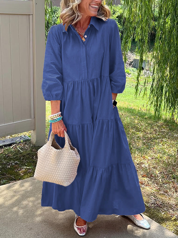 Robe longue bleu nuit à col boutonné, manches bouffantes, jupe évasée à volants.