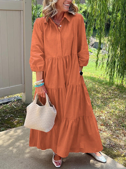 Robe longue orange à boutons, encolure ronde, manches bouffantes et jupe à volants