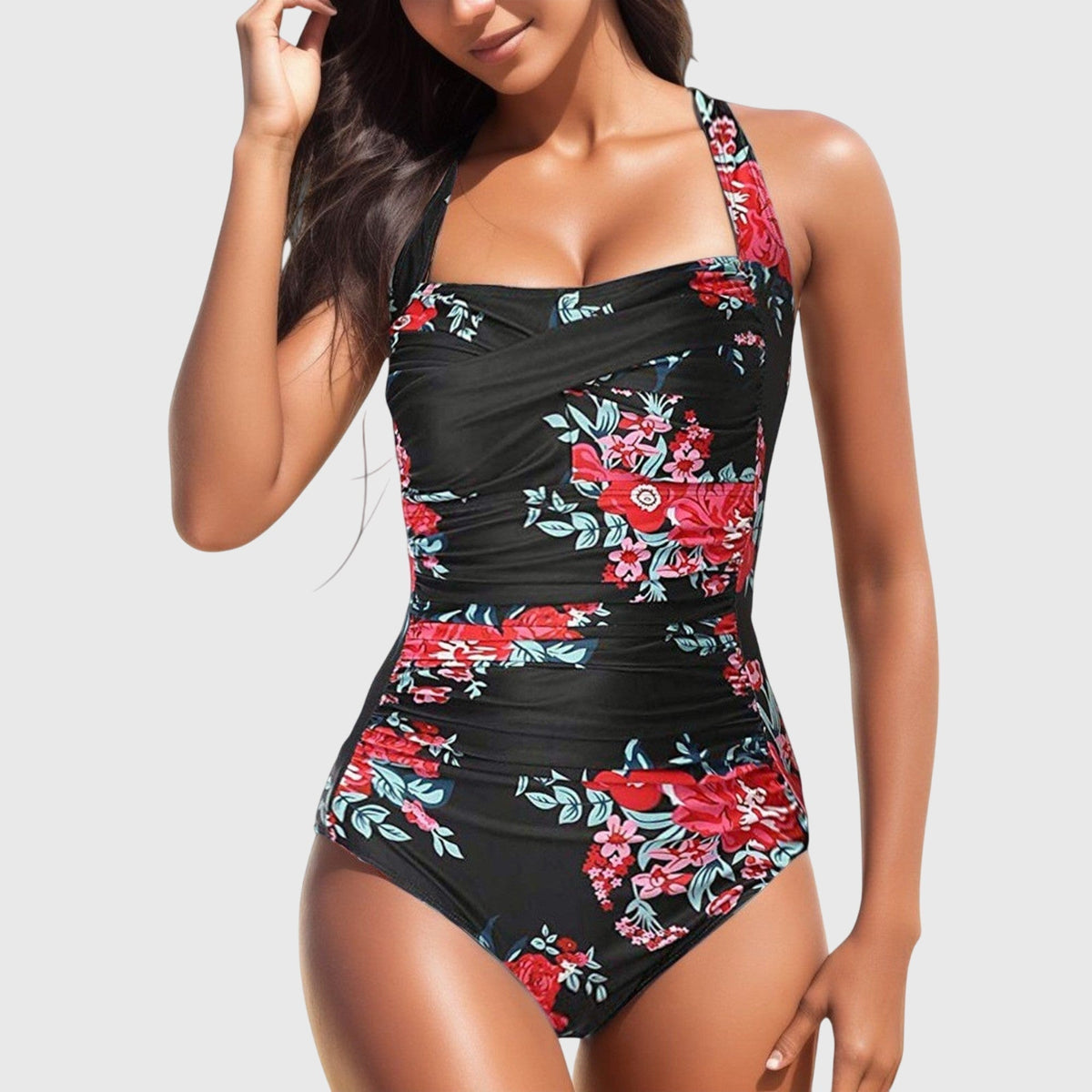 Maillot une-pièce noir à fleurs rouges et vertes, bretelles fines et décolleté carré