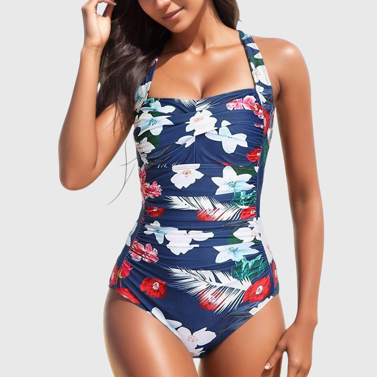 Maillot une-pièce bleu marine à fleurs blanches et rouges, bretelles fines et décolleté carré