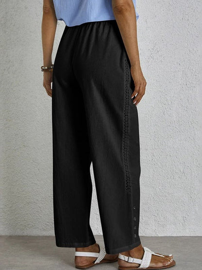 Pantalon ample noir avec taille élastique et cordon, boutons décoratifs latéraux