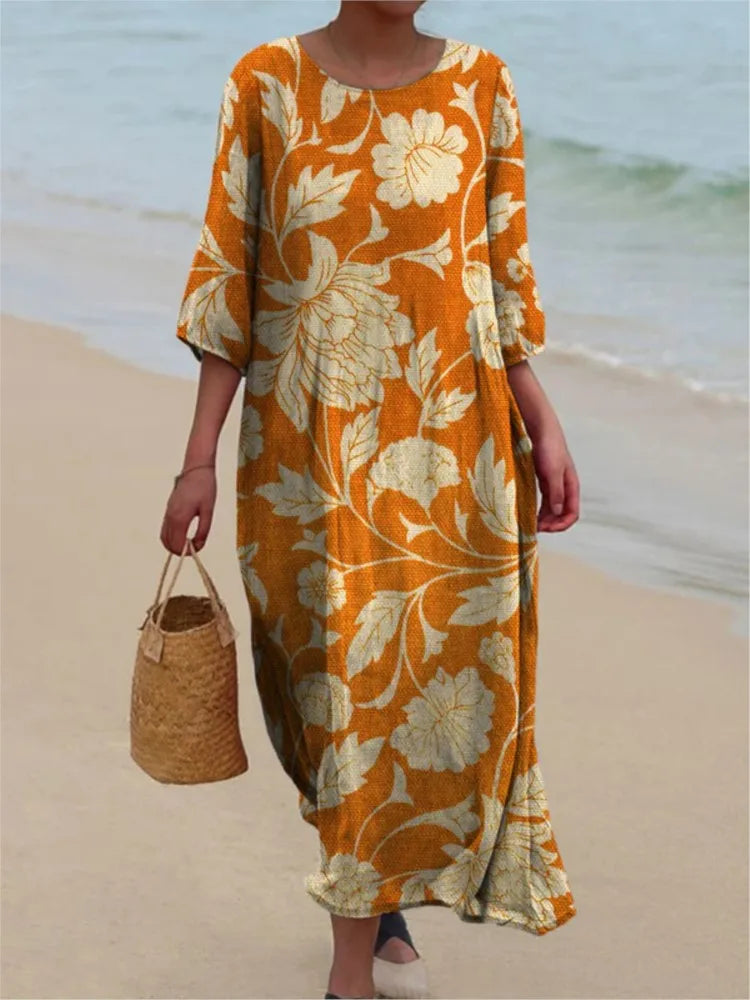 Robe vintage longue orange à grandes fleurs, encolure ronde, manches mi-longues.
