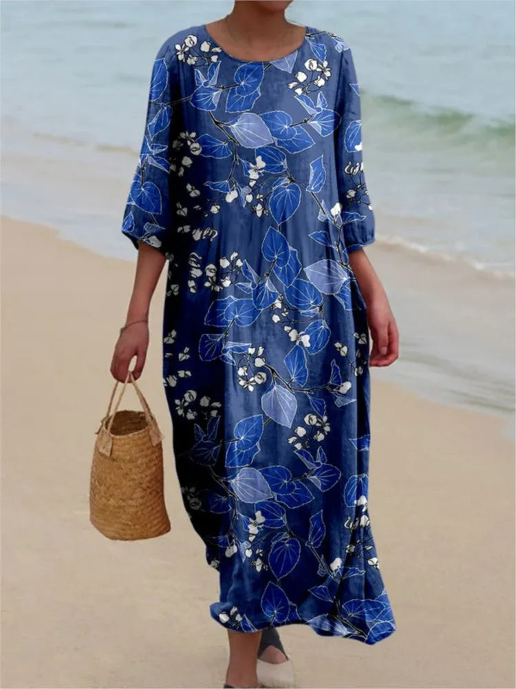 Robe vintage longue bleu à fleurs blanches, encolure ronde, manches amples.