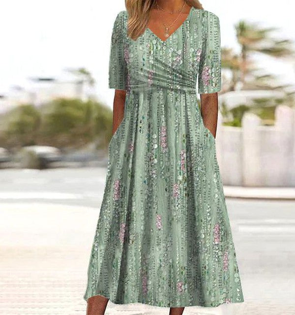 Robe midi vert clair à imprimé botanique, encolure V et manches courtes évasées.