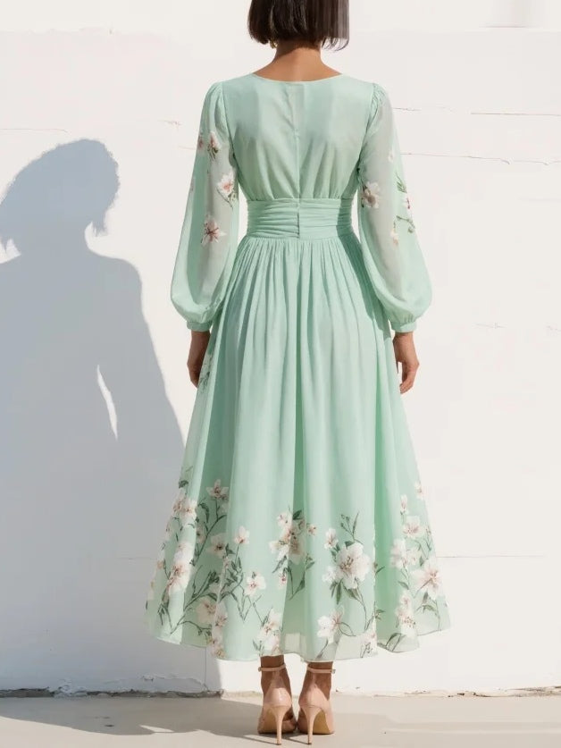 Robe midi vert clair plissée au dos, manches longues bouffantes, imprimé fleuri.