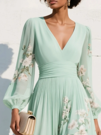 Robe midi vert clair col V, buste froncé, manches bouffantes, imprimé fleurs.