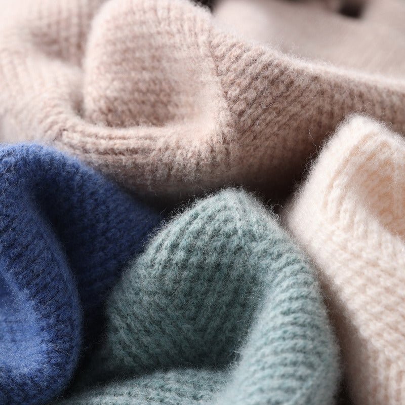 Pull en cachemire, gros plan sur la maille: tons bleu, vert, beige et gris