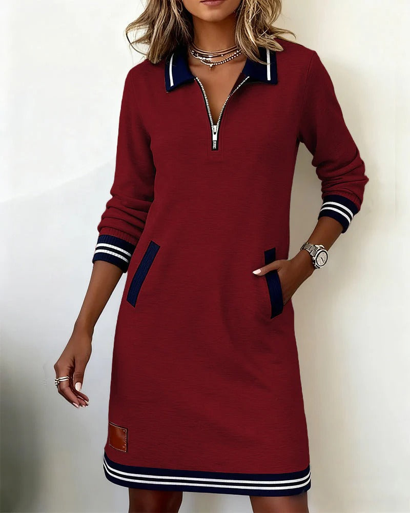 Robe sport-chic rouge bordeaux mi-longue à zip, col bleu marine, manches rayées et ourlet.