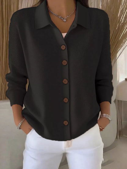 Chemisier en maille noire à col chemise et boutons visibles sur le devant