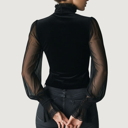 Blouse en dentelle Elvira noire, dos en voile, manches transparentes, col haut.