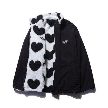 Veste réversible enfant noire et blanche à cœurs, capuche et fermeture zippée.