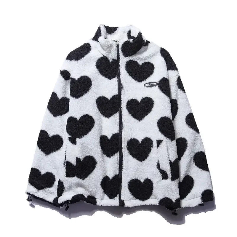 Veste réversible enfant en polaire blanche à cœurs noirs, capuche et fermeture zip.