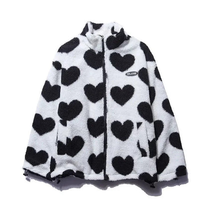 Veste réversible enfant en polaire blanche à cœurs noirs, capuche et fermeture zip.