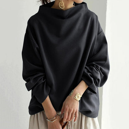Haut ample noir à col cheminée et manches bouffantes, style chic décontracté
