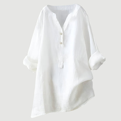 Chemise ample en lin blanc, encolure en V, patte boutonnée, manches larges.