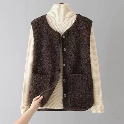 Gilet polaire douillet marron foncé, col montant, fermeture boutonnée, poches plaquées.
