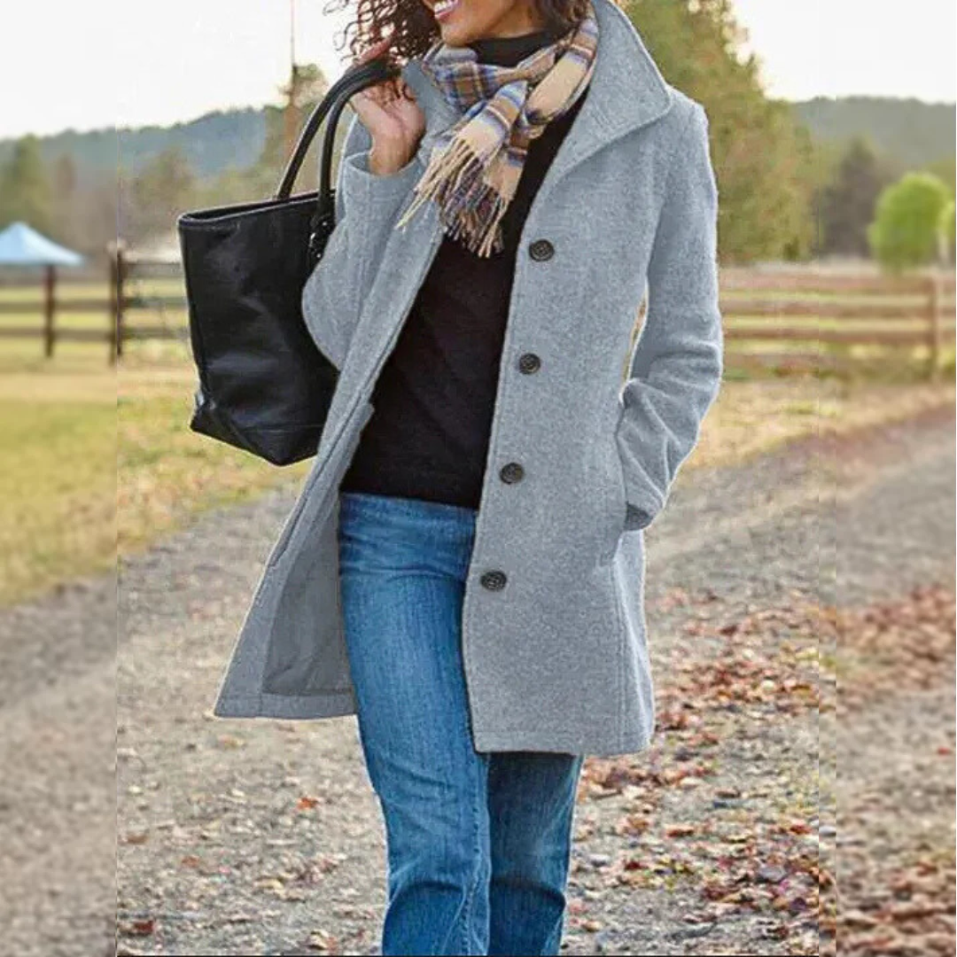 Veste classique mi-longue gris clair à boutons, col revers et poches plaquées.