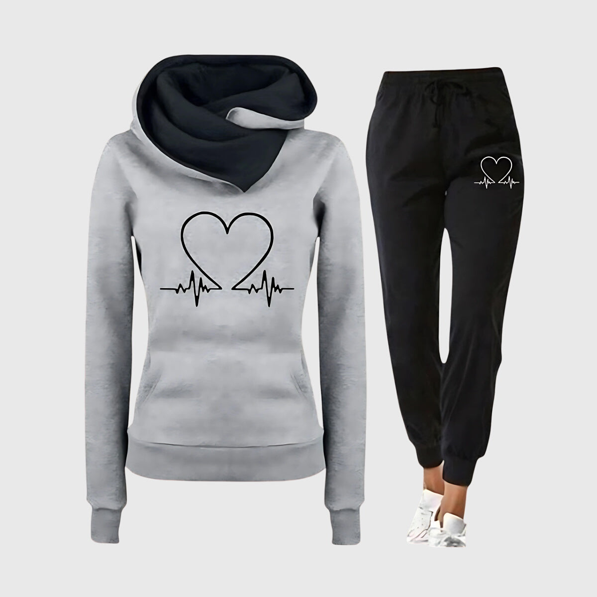 Ensemble sweat à capuche gris et jogging noir, motif cœur avec ligne de rythme cardiaque.