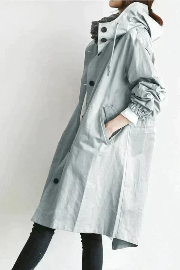 Trench-coat déperlant gris clair à capuche, manches froncées et patte boutonnée