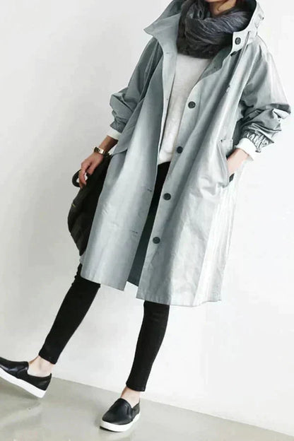 Trench-coat déperlant gris clair à capuche, boutons noirs et col montant