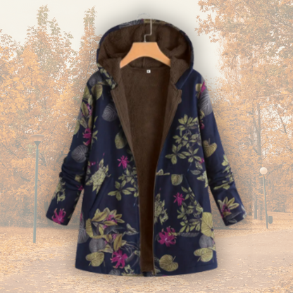 Veste à capuche doublée polaire, tissu bleu foncé fleuri multicolore, fermeture zippée.