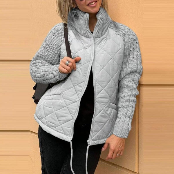Veste matelassée grise avec zip, surpiqûres en losanges et manches en maille côtelée