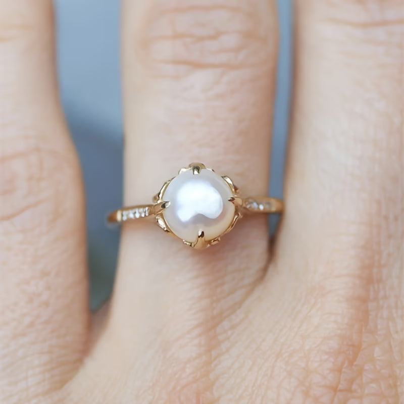 Bague dorée avec perle ronde blanche et petits cristaux, monture à griffes