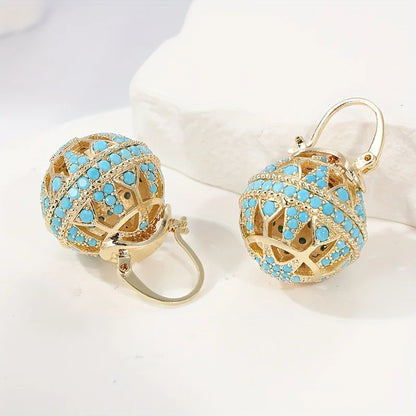Boucles d’oreilles mandala turquoise doré, vue de face sur fond clair