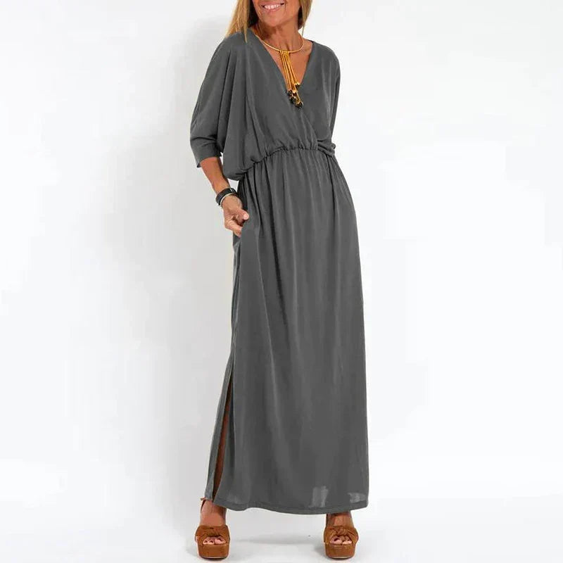 Robe longue vintage gris foncé, manches 3/4 bouffantes, taille froncée, fente latérale.