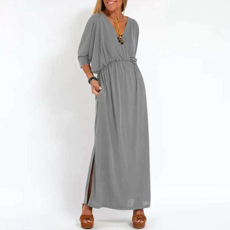 Robe longue vintage grise, manches 3/4 bouffantes, taille froncée, fente latérale.