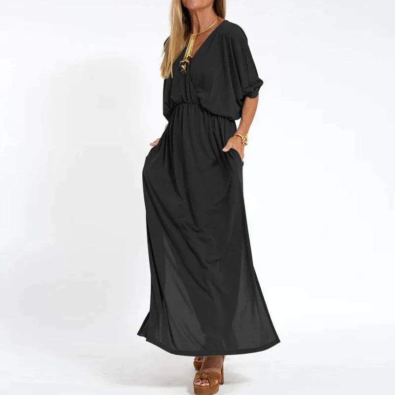 Robe longue vintage noire, manches 3/4 bouffantes, taille froncée, fente latérale.