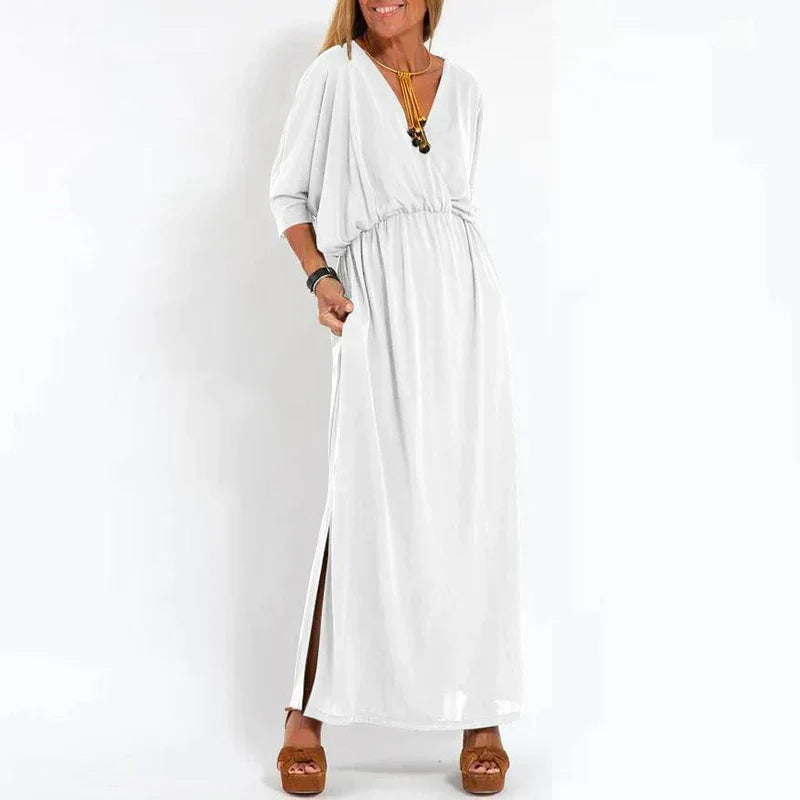 Robe longue vintage blanche, manches 3/4 bouffantes, taille froncée, fente latérale.