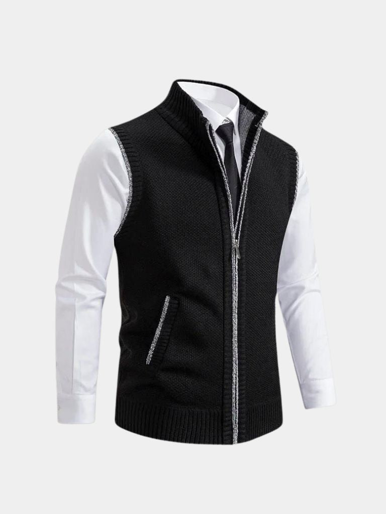 Gilet noir à fermeture éclair intégrale, maille structurée, col montant, poche poitrine.