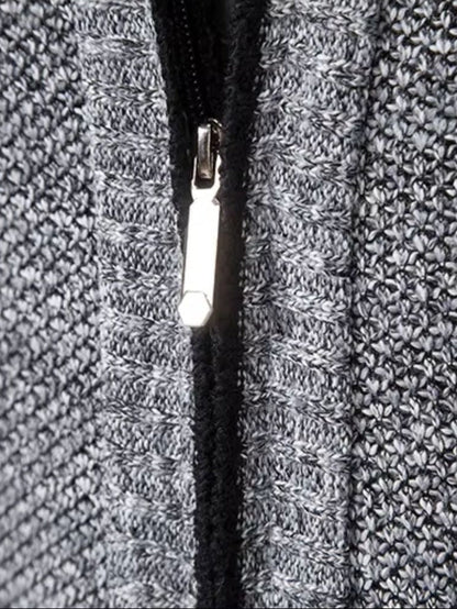 Gilet gris : fermeture éclair noire sur maille texturée, détail de la glissière.